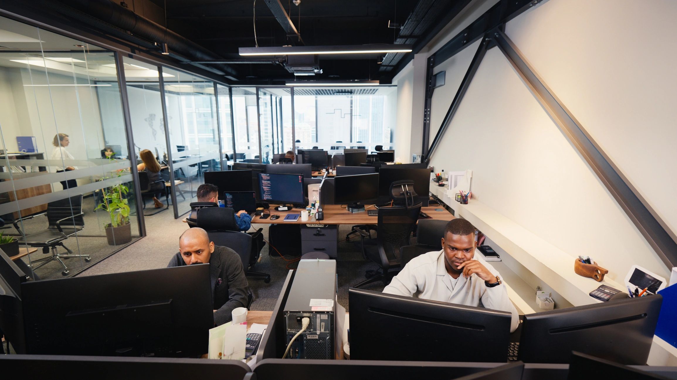 Modern IT support team working together in a professional office